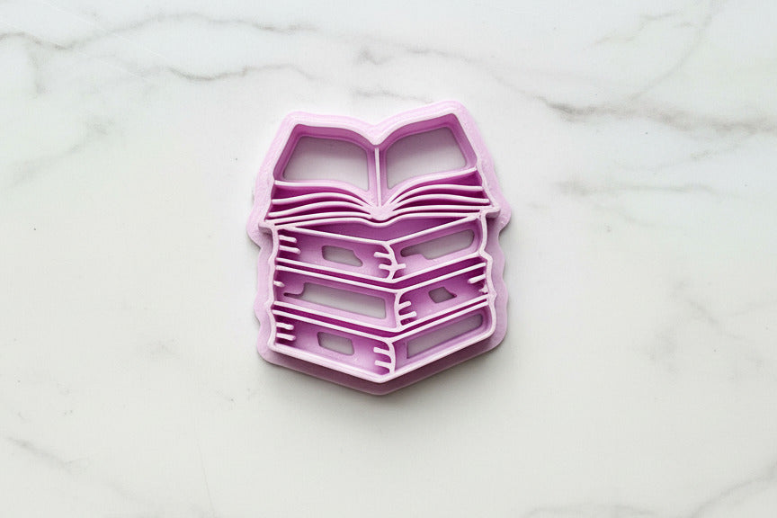stack of books with one open