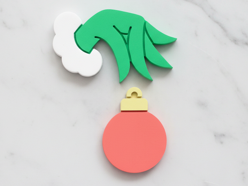 Grinch hand and ornament
