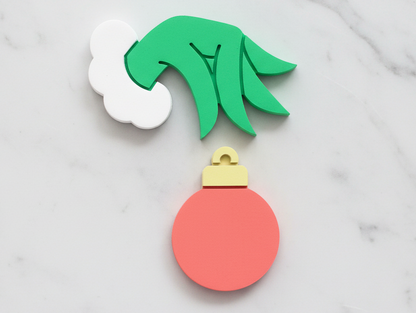 Grinch hand and ornament